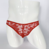 HU: Crimson Whisper piros csipkés férfi tanga elölnézetben, fehér próbababán. EN: Crimson Whisper red lace men’s thong shown from the front on a white mannequin.